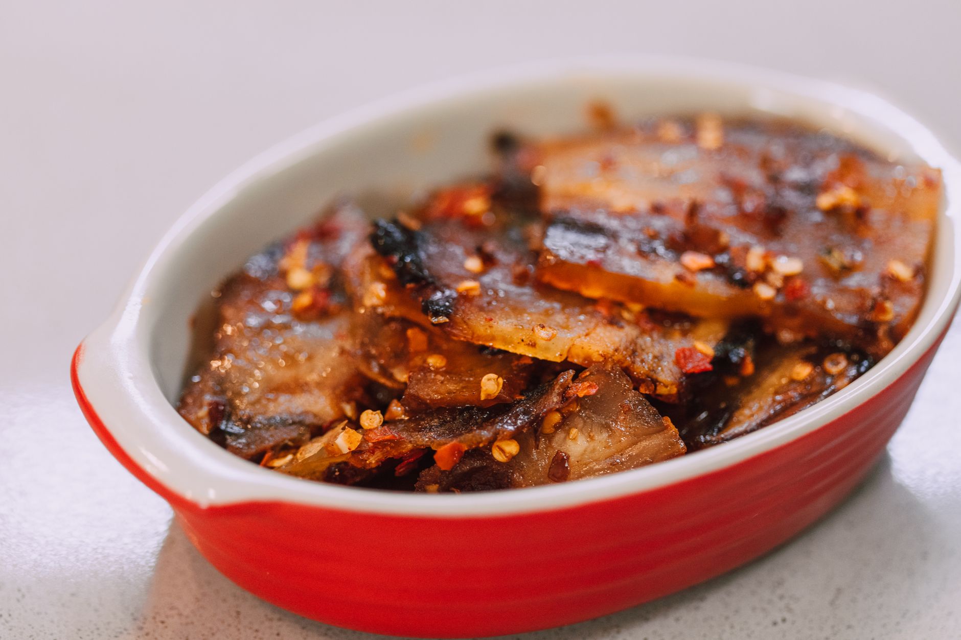 Sticky five-spice pork belly with ginger & plums